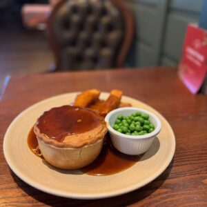 Close-up of golden pies and traditional sides served at The Punch Bowl