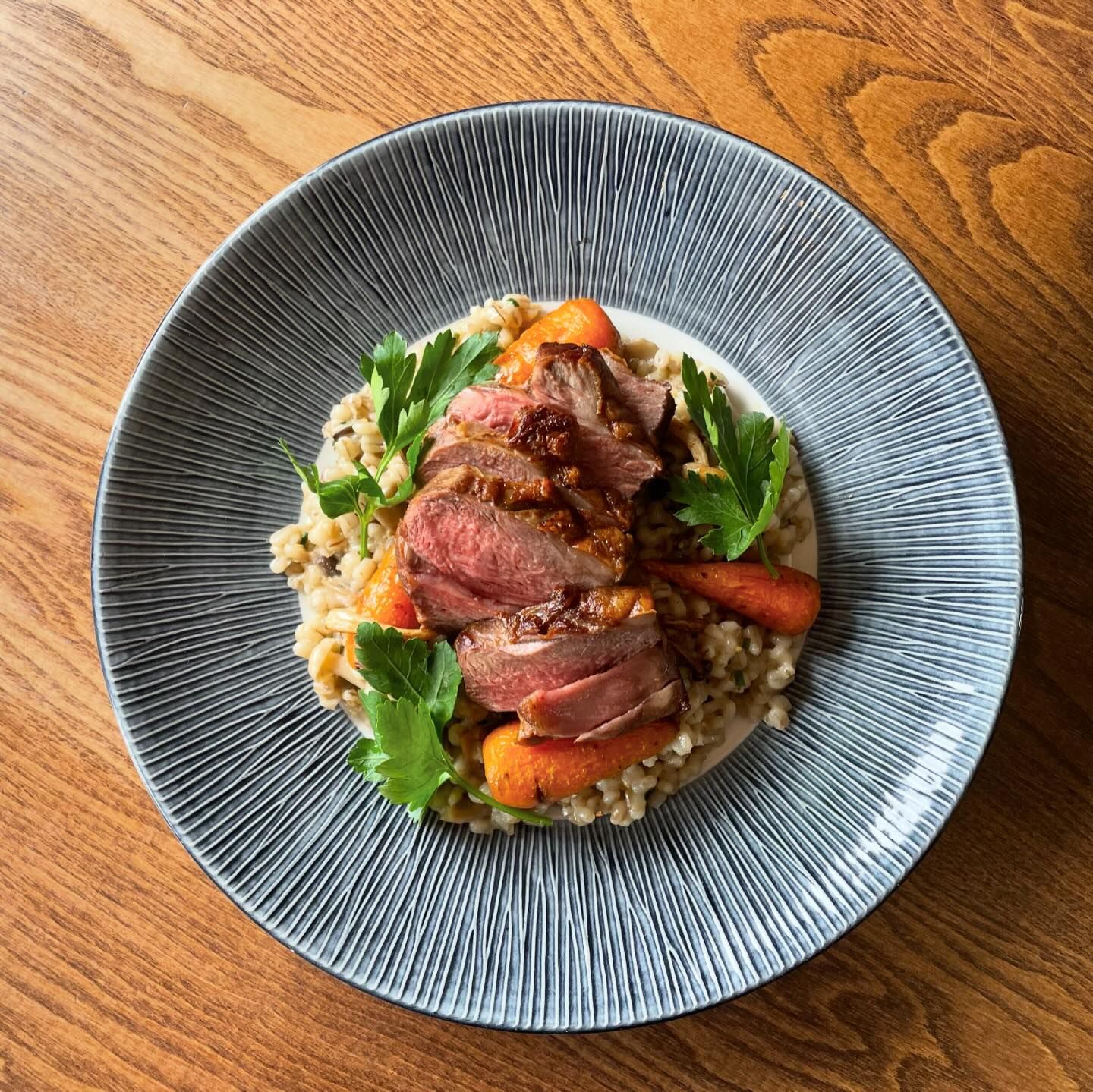Supper club crookes steak on a bed of pearl barley, wild mushrooms, and carrots.
